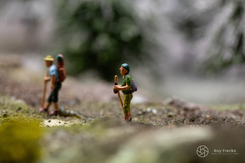 Twee miniatuur wandelaars met rugzak